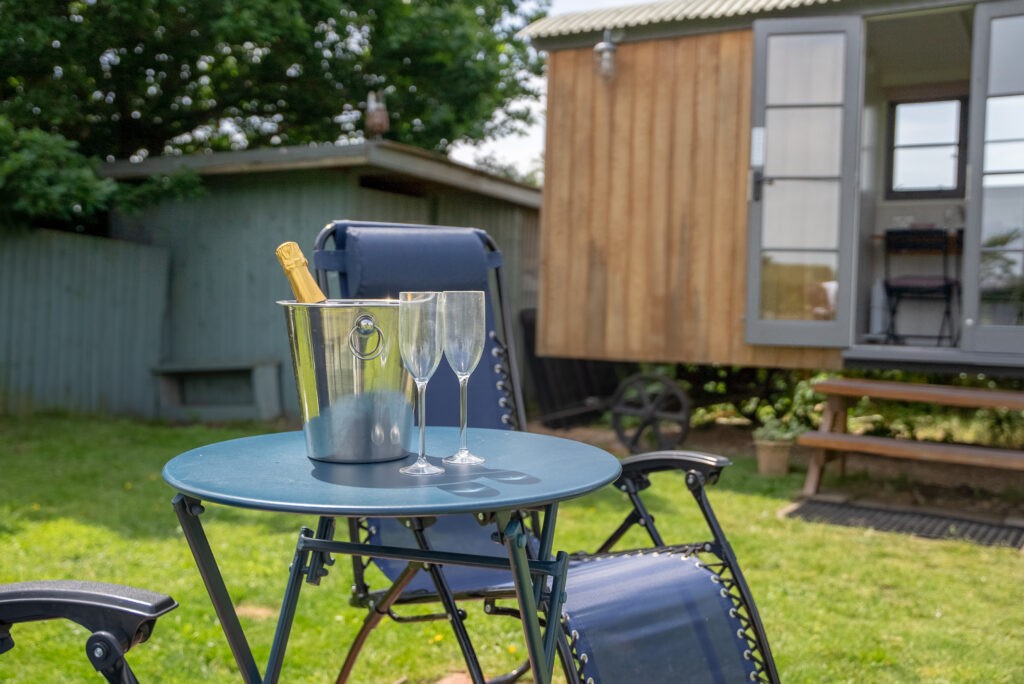Image of prosecco flutes next to the Pheasants Roost exterior. Romantic Break in Yorkshire
